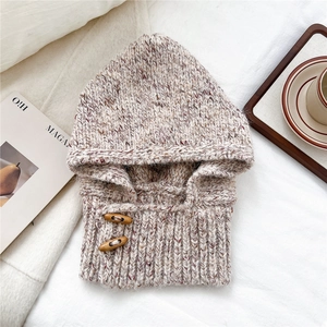 Close-up of knit balaclava scarf with ribbed texture and two wooden toggle buttons