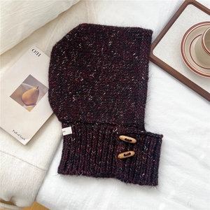 Close-up of thick wine red knit balaclava hood with rustic wooden toggle buttons