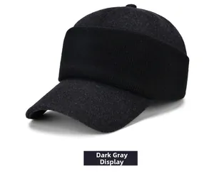 Detail of dark grey winter baseball cap with black knit trim and thermal felt texture