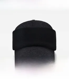 Detail view of winter knitted cap for men with warm ear flaps in dark grey and black