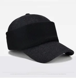 Detail of dark grey blended wool baseball cap with black ribbed knit trim and textured fabric
