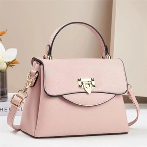 Detail showing light pink lychee pattern leather texture and golden rivet square lock