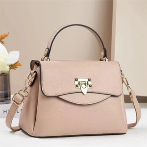Elegant pale pink crossbody bag with gold hardware and top handle for women