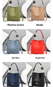 Detail view of stylish bucket bag with cat pendant available in six multiple color options