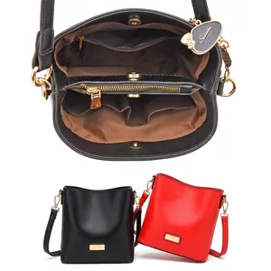 Internal structure of minimalist bucket bag showing main pockets and zipper compartments