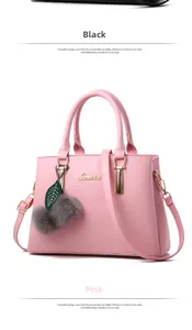 Detailed view of pink pebble leather handbag with gold logo and plush pompom charm