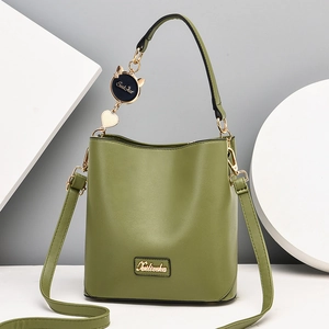 Minimalist green leather bucket bag with top handle and crossbody strap for women
