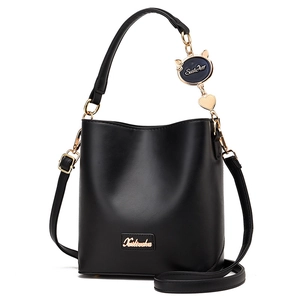 Black minimalist bucket bag with cat pendant and adjustable strap for women