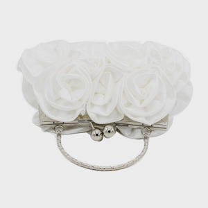 Detailed view of white satin rose evening bag with silver metal ring handle