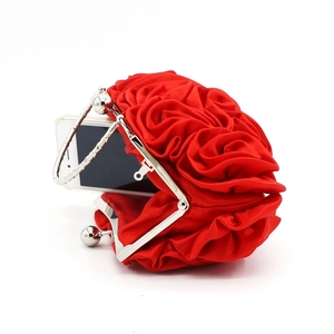 Detail of red satin rose evening bag showing internal capacity with a smartphone inside