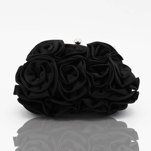 Close-up of black satin evening bag featuring handmade 3D rose petals and silver ball clasp