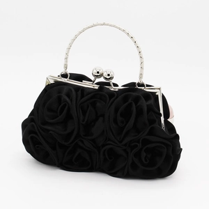 Detail of black satin evening bag with 14 handmade roses and metal handle