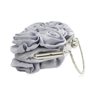 Detail of light gray satin clutch with handmade rose petals and silver kiss lock