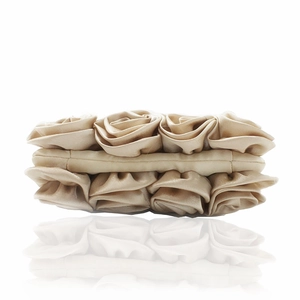 Detailed close-up of champagne satin rose floral embellishments on a luxury evening clutch