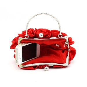 Detail of red satin rose evening bag showing interior capacity and silver metal handle