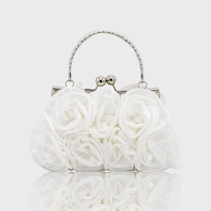 Detail of white satin evening bag with handmade 3D fabric roses and silver arch handle