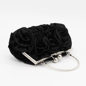 Detail of elegant black satin evening bag featuring 3D handmade fabric rose floral pattern