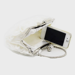 Detail view of the white satin rose evening bag showing phone capacity and silver chain
