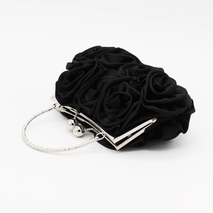 Detailed view of black 3D satin rose petals on an elegant evening clutch bag with ring