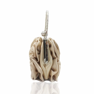 Detail of champagne satin evening bag with 3D handmade roses and silver metal handle