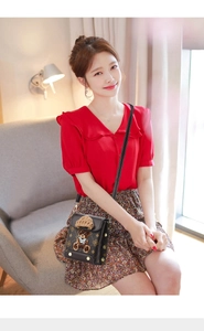 Detail of crossbody bag with cute 3D bear doll ornament on a warm home interior background