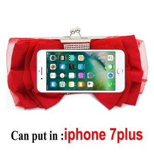 Detail showing the red bow evening clutch capacity fitting an iPhone 7 Plus