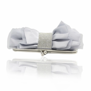 Macro shot of grey satin clutch featuring a large bow and sparkling diamond center band