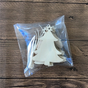 Detail of DIY wooden Christmas tree pendants with hanging ropes in plastic packaging