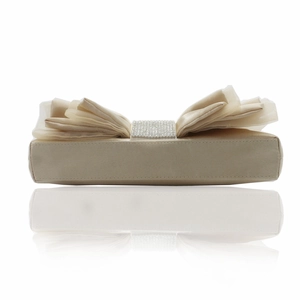 Macro detail of beige satin evening bag with layered fabric bow and crystal buckle
