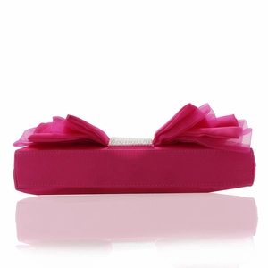 Close-up of pink satin evening clutch featuring oversized tulle bow and rhinestone detail
