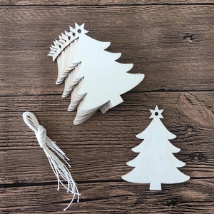 Close-up of stacked wooden Christmas tree ornaments with natural grain and jute twine
