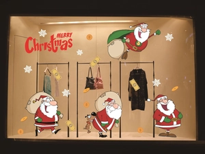 Detailed shop window display of Santa Claus static stickers with Merry Christmas text