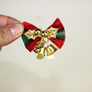 Mini Christmas bow decoration with red plaid fabric, holly leaves, and gold bells detail