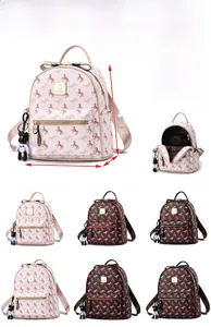 Detail view of large and small women's soft PU leather backpacks with horse print and charms
