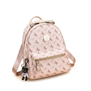 Small beige backpack with pink horse prints, gold zipper, and black bear pendant charm