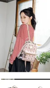 Soft faux leather mini backpack with horse print and cute bear keychain on model