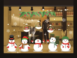 Detail view of festive snowman and snowflake static stickers on a glass store window