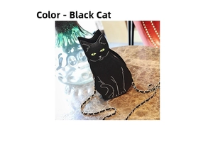 Detail of cute black cat crossbody bag featuring gold chain strap and animal design