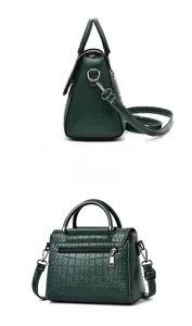 Detailed back and side view of dark green crocodile embossed crossbody bag with silver zipper