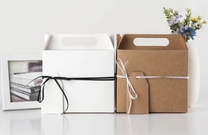 Detail view of hexagonal kraft gift boxes with elegant ribbon and hanging blank tags