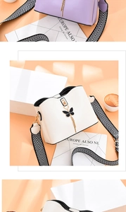 Détail du sac bandoulière blanc avec charm papillon noir et sangle à motifs stylée