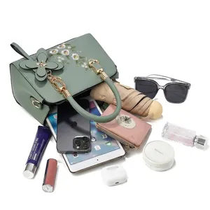 Olive green floral embroidered tote bag showing large capacity for tablet and cosmetics