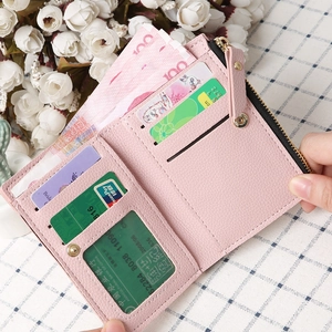 Detail of pink faux leather wallet featuring card slots and a photo holder compartment