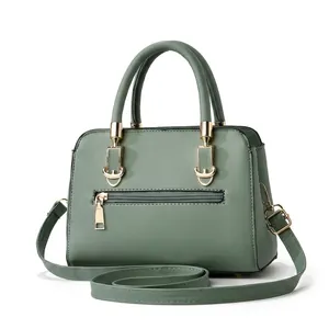 Detail view of large bean green leather tote bag with gold hardware and side zipper