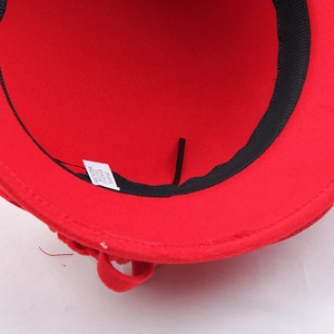 Detail view of the interior lining and wool blend fabric label of the red fedora hat