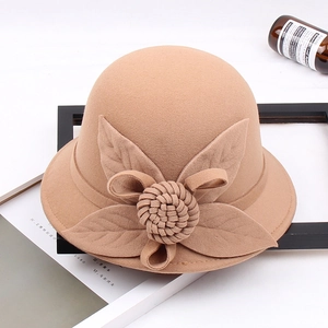Detailed texture of camel wool felt hat with decorative 3D floral and leaf accents