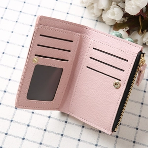 Interior detail of pink PU leather wallet with card slots and a clear ID window