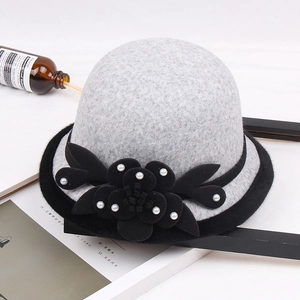 Detailed view of gray wool felt fedora featuring black fabric flower with pearl accents