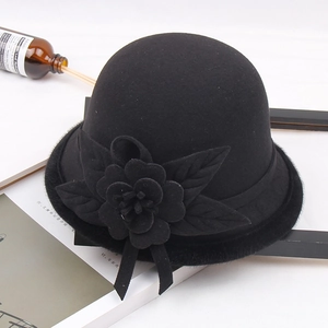 Close-up of vintage black wool fedora featuring 3D floral decoration and leaf accents