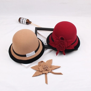 Close-up of wool felt cloche hat featuring vintage floral accents and black ribbon trim